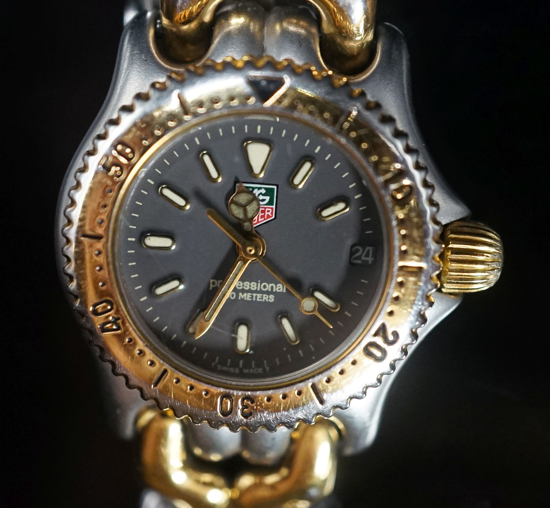 A lady's modern steel and gold plated Tag Heuer Professional quartz wrist watch, no box or papers.